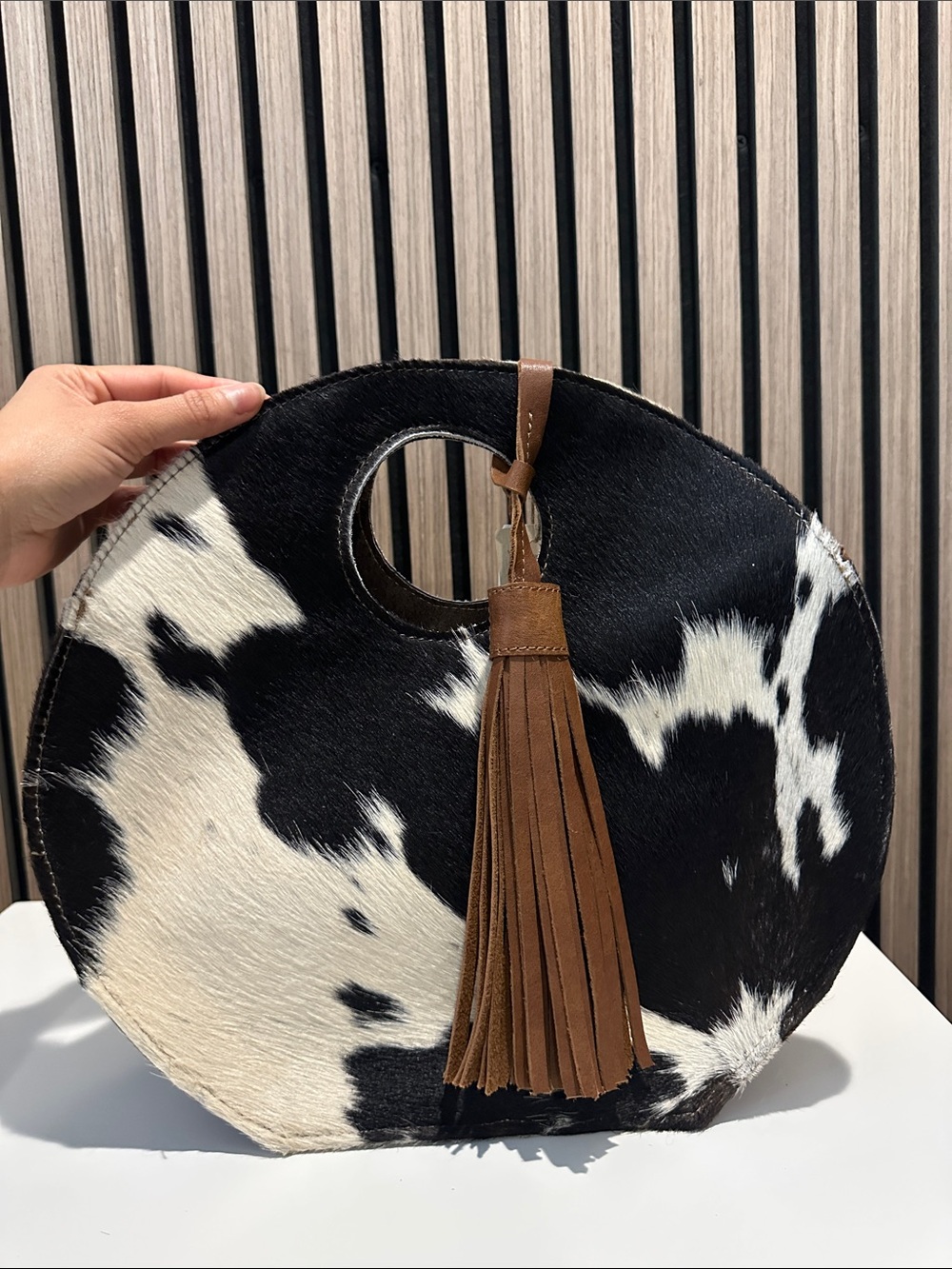 Round Black & White Cowhide Tote with Brown Tassel Accent